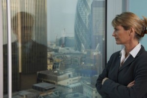 9007404-business-woman-looking-out-of-window-with-reflection-of-business-man-looking-back
